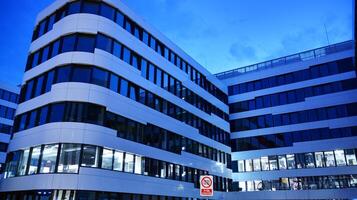 Pattern of office buildings windows illuminated at night. Glass architecture ,corporate building at night - business concept. photo