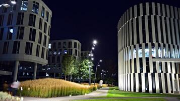 Pattern of office buildings windows illuminated at night. Glass architecture ,corporate building at night - business concept. photo