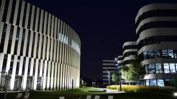 Pattern of office buildings windows illuminated at night. Glass architecture ,corporate building at night - business concept. photo