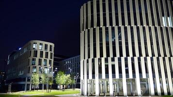 Pattern of office buildings windows illuminated at night. Glass architecture ,corporate building at night - business concept. photo