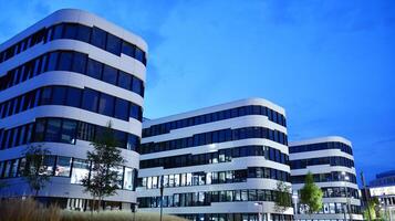 Pattern of office buildings windows illuminated at night. Glass architecture ,corporate building at night - business concept. photo