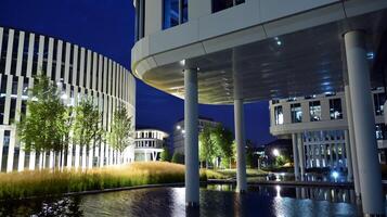 Pattern of office buildings windows illuminated at night. Glass architecture ,corporate building at night - business concept. photo