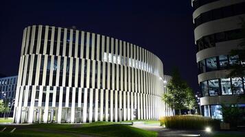 Pattern of office buildings windows illuminated at night. Glass architecture ,corporate building at night - business concept. photo