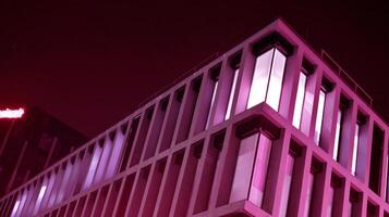 Night architecture - building with glass facade. Modern building in business district. Concept of economics, financial. Photo of commercial office building exterior. Abstract image of office building