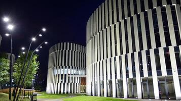 Pattern of office buildings windows illuminated at night. Glass architecture ,corporate building at night - business concept. photo