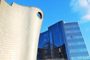 Structural glass wall reflecting blue sky. Abstract modern architecture fragment photo