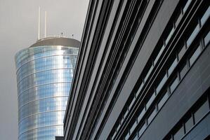 Structural glass wall reflecting blue sky. Abstract modern architecture fragment. photo