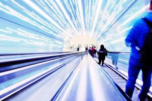 Blurred backround of moving futuristic escalator. Blurred image.Post process in vintage style photo