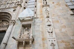 Exterior of the Cathedral in Como city, with Italian architectural details, sculpture, stone carvings. Lombardy. Italy photo