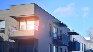 Modern apartment building in sunny day. Exterior, residential house facade. Residential area with modern, new and stylish living block of flats. photo