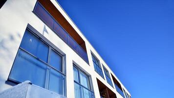 Modern apartment building in sunny day. Exterior, residential house facade. Residential area with modern, new and stylish living block of flats. photo