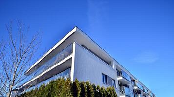 Modern apartment building in sunny day. Exterior, residential house facade. Residential area with modern, new and stylish living block of flats. photo