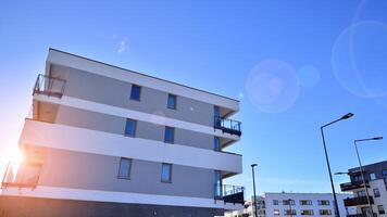 Modern apartment building in sunny day. Exterior, residential house facade. Residential area with modern, new and stylish living block of flats. photo