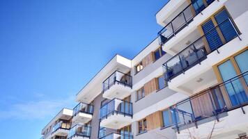 Modern apartment building in sunny day. Exterior, residential house facade. Residential area with modern, new and stylish living block of flats. photo