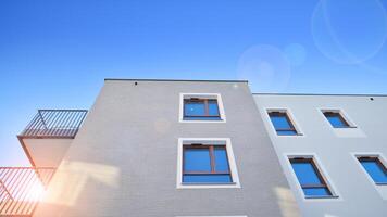 Modern apartment building in sunny day. Exterior, residential house facade. Residential area with modern, new and stylish living block of flats. photo