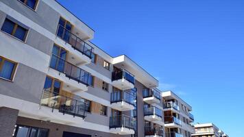 Modern apartment building in sunny day. Exterior, residential house facade. Residential area with modern, new and stylish living block of flats. photo