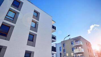 Modern apartment building in sunny day. Exterior, residential house facade. Residential area with modern, new and stylish living block of flats. photo