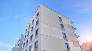 Modern apartment building in sunny day. Exterior, residential house facade. Residential area with modern, new and stylish living block of flats. photo