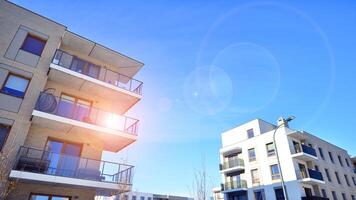 Modern apartment building in sunny day. Exterior, residential house facade. Residential area with modern, new and stylish living block of flats. photo