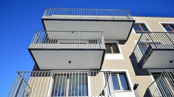 Modern apartment building in sunny day. Exterior, residential house facade. Residential area with modern, new and stylish living block of flats. photo