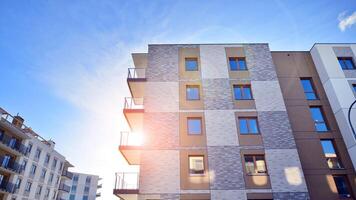 Modern apartment building in sunny day. Exterior, residential house facade. Residential area with modern, new and stylish living block of flats. photo