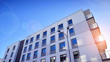 Modern apartment building in sunny day. Exterior, residential house facade. Residential area with modern, new and stylish living block of flats. photo