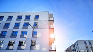 Modern apartment building in sunny day. Exterior, residential house facade. Residential area with modern, new and stylish living block of flats. photo