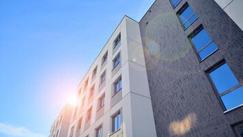 Modern apartment building in sunny day. Exterior, residential house facade. Residential area with modern, new and stylish living block of flats. photo