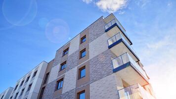 Modern apartment building in sunny day. Exterior, residential house facade. Residential area with modern, new and stylish living block of flats. photo