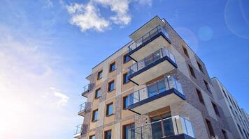 Modern apartment building in sunny day. Exterior, residential house facade. Residential area with modern, new and stylish living block of flats. photo