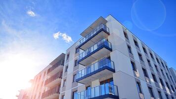 Modern apartment building in sunny day. Exterior, residential house facade. Residential area with modern, new and stylish living block of flats. photo