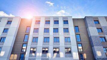 Modern apartment building in sunny day. Exterior, residential house facade. Residential area with modern, new and stylish living block of flats. photo