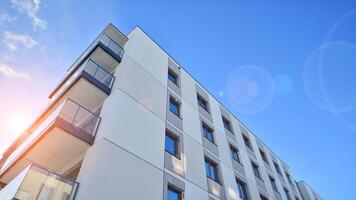 Modern apartment building in sunny day. Exterior, residential house facade. Residential area with modern, new and stylish living block of flats. photo