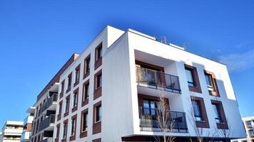 Modern apartment building in sunny day. Exterior, residential house facade. Residential area with modern, new and stylish living block of flats. photo