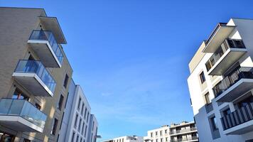 Modern apartment building in sunny day. Exterior, residential house facade. Residential area with modern, new and stylish living block of flats. photo