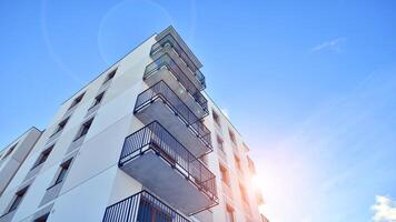 Modern apartment building in sunny day. Exterior, residential house facade. Residential area with modern, new and stylish living block of flats. photo