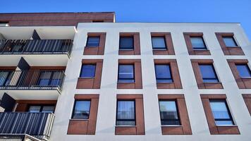 Modern apartment building in sunny day. Exterior, residential house facade. Residential area with modern, new and stylish living block of flats. photo