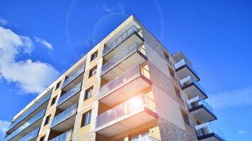 Modern apartment building in sunny day. Exterior, residential house facade. Residential area with modern, new and stylish living block of flats. photo