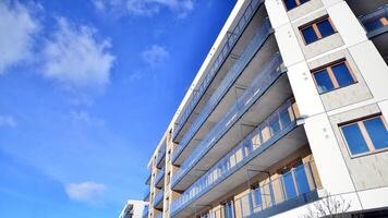 Modern apartment building in sunny day. Exterior, residential house facade. Residential area with modern, new and stylish living block of flats. photo