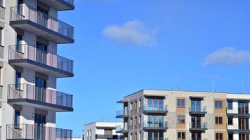 Modern apartment building in sunny day. Exterior, residential house facade. Residential area with modern, new and stylish living block of flats. photo