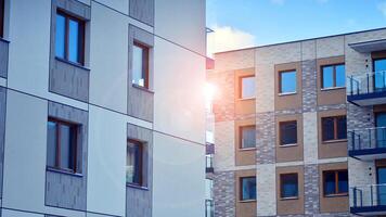 Modern apartment building in sunny day. Exterior, residential house facade. Residential area with modern, new and stylish living block of flats. photo