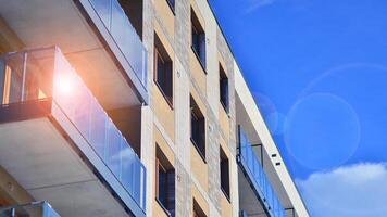 Modern apartment building in sunny day. Exterior, residential house facade. Residential area with modern, new and stylish living block of flats. photo