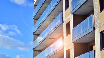 Modern apartment building in sunny day. Exterior, residential house facade. Residential area with modern, new and stylish living block of flats. photo