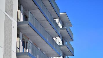 Modern apartment building in sunny day. Exterior, residential house facade. Residential area with modern, new and stylish living block of flats. photo