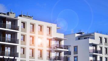 Modern apartment building in sunny day. Exterior, residential house facade. Residential area with modern, new and stylish living block of flats. photo