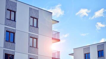 Modern apartment building in sunny day. Exterior, residential house facade. Residential area with modern, new and stylish living block of flats. photo