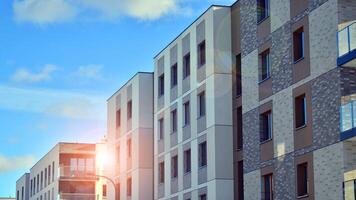 Modern apartment building in sunny day. Exterior, residential house facade. Residential area with modern, new and stylish living block of flats. photo