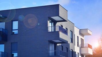 Modern apartment building in sunny day. Exterior, residential house facade. Residential area with modern, new and stylish living block of flats. photo