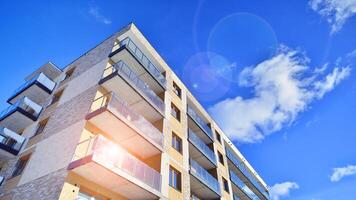 Modern apartment building in sunny day. Exterior, residential house facade. Residential area with modern, new and stylish living block of flats. photo