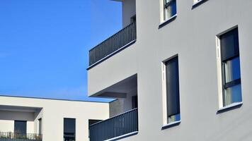 Modern apartment building in sunny day. Exterior, residential house facade. Residential area with modern, new and stylish living block of flats. photo